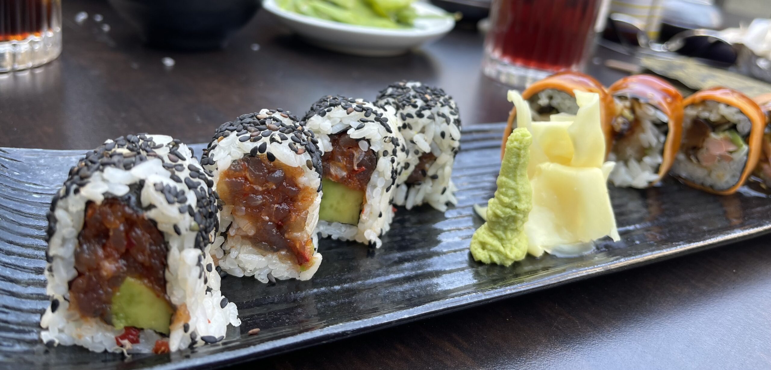 sushi rolls on a black plate